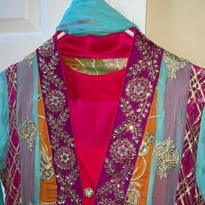 suit with heavy embroidery and details